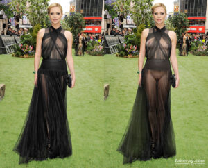 Charlize Theron fakeray of black transparent dress with Chalize standing in public on grass and holding purse.
