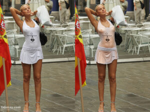 Woman standing on street with nipples poking trough thin white dress