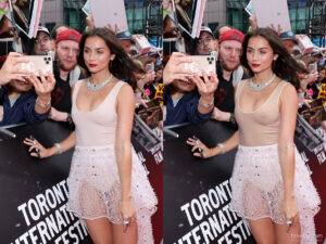 Celebrity posing for photograph in her dress that barely covers her body and intimate parts.